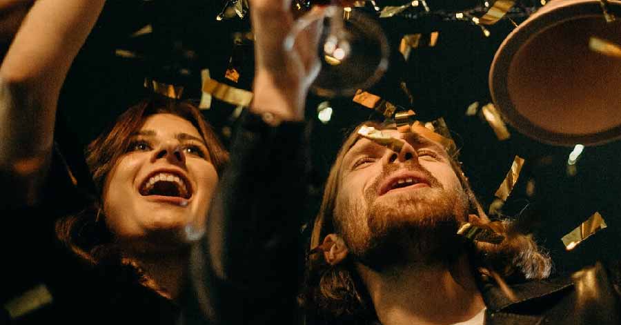 friends having a champagne toast with confetti