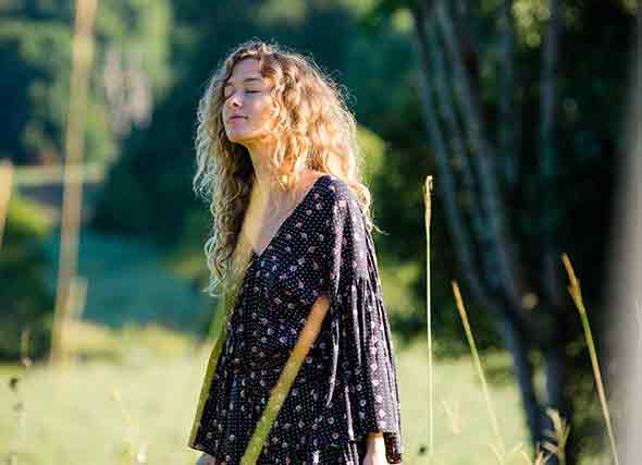 woman standing in grassfield