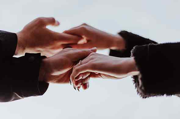  A photo of a couple’s hands that are intertwined