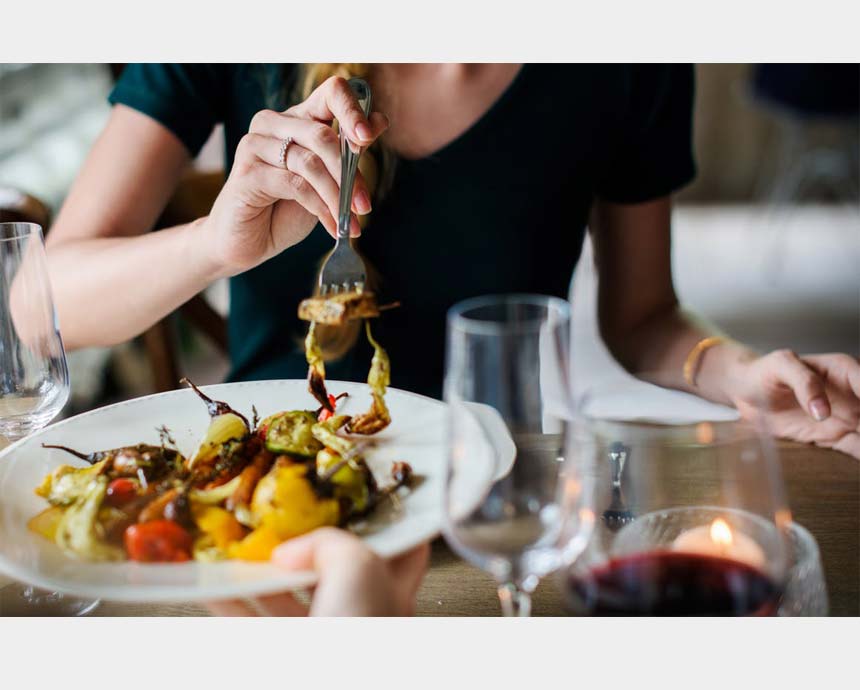 A woman about to eat the salad.